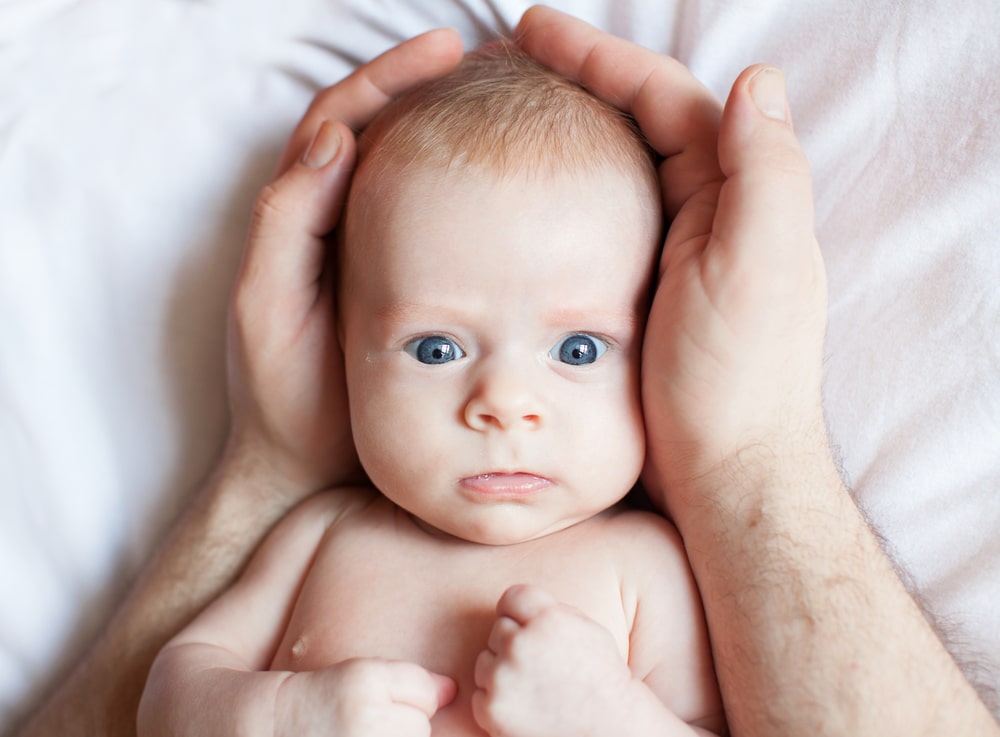 Baby in father's hands - Leo Man As A Father