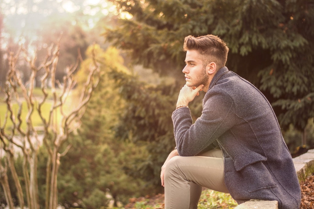 Handsome serious young man outdoors thinking - Leo Man With Virgo Rising